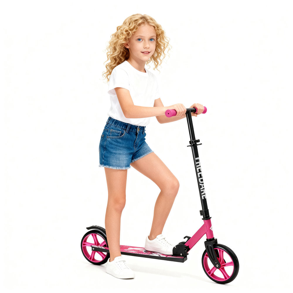 Young girl riding a pink scooter on a white background